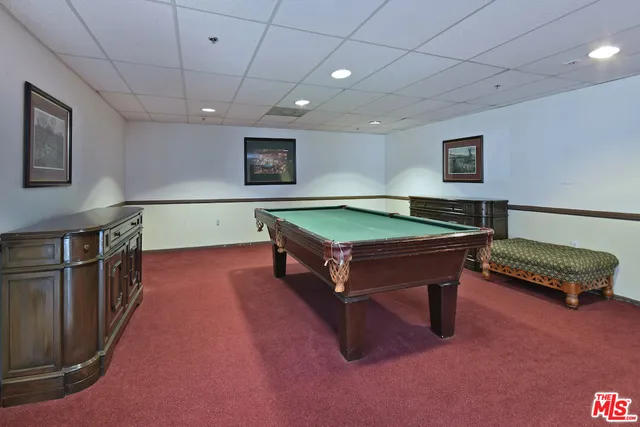a room with furniture pool table and flat screen tv