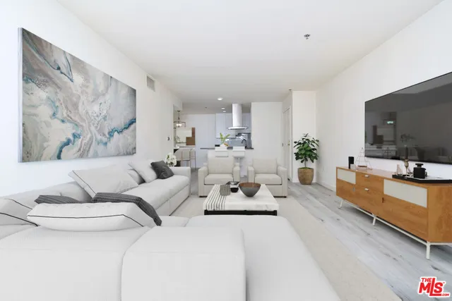 a living room with furniture flat screen tv and a couch