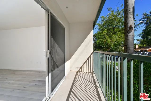 a view of balcony with wooden floor and fence