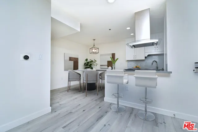 a kitchen with a sink cabinets and wooden floor
