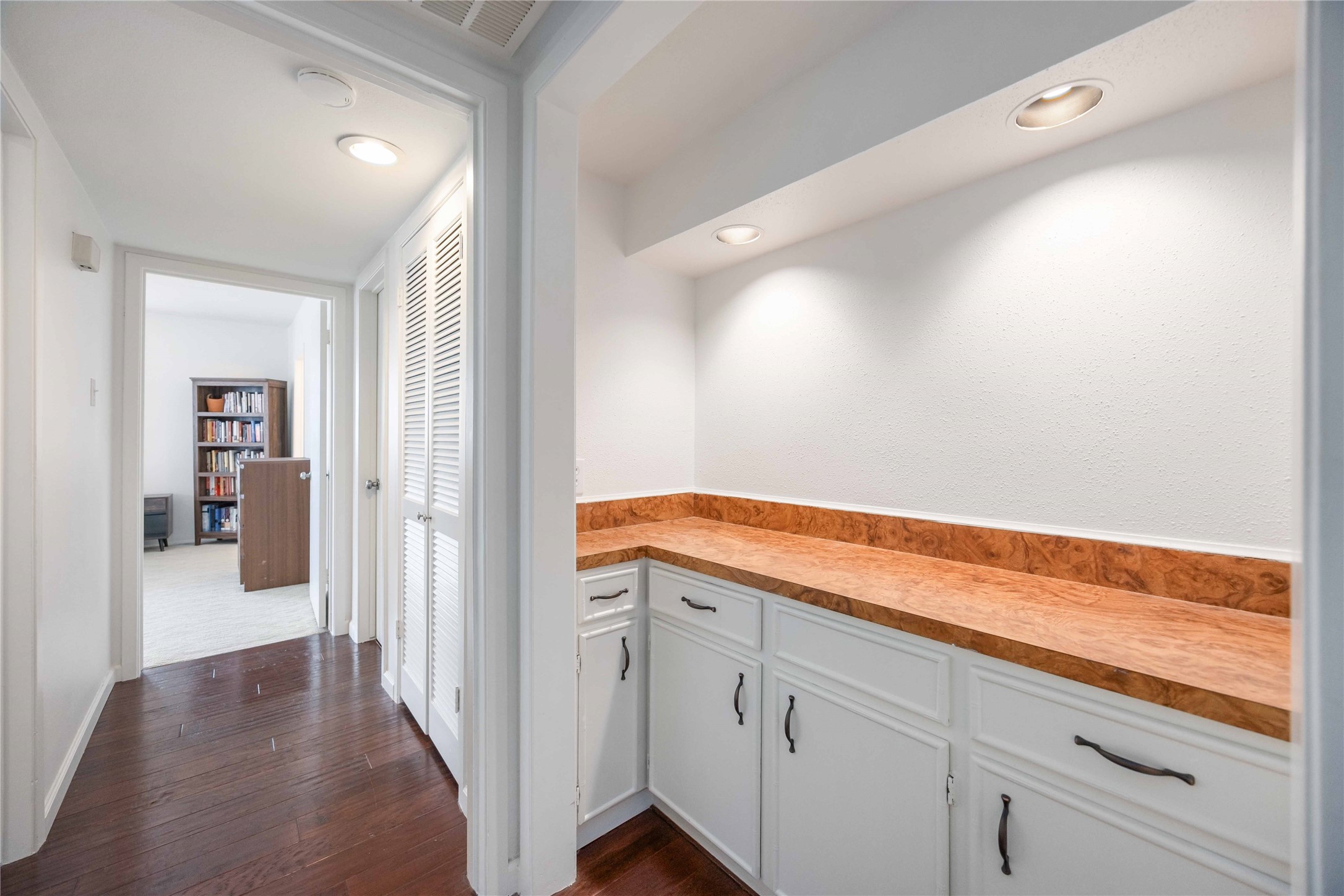 2230 South Piney Point Road, Unit 206 Houston, TX 77063 - Photo 11 of 24 Another view of the hallway leading to the bedrooms. A laundry closet past the dry bar contains a stackable washer/dryer included with the unit.