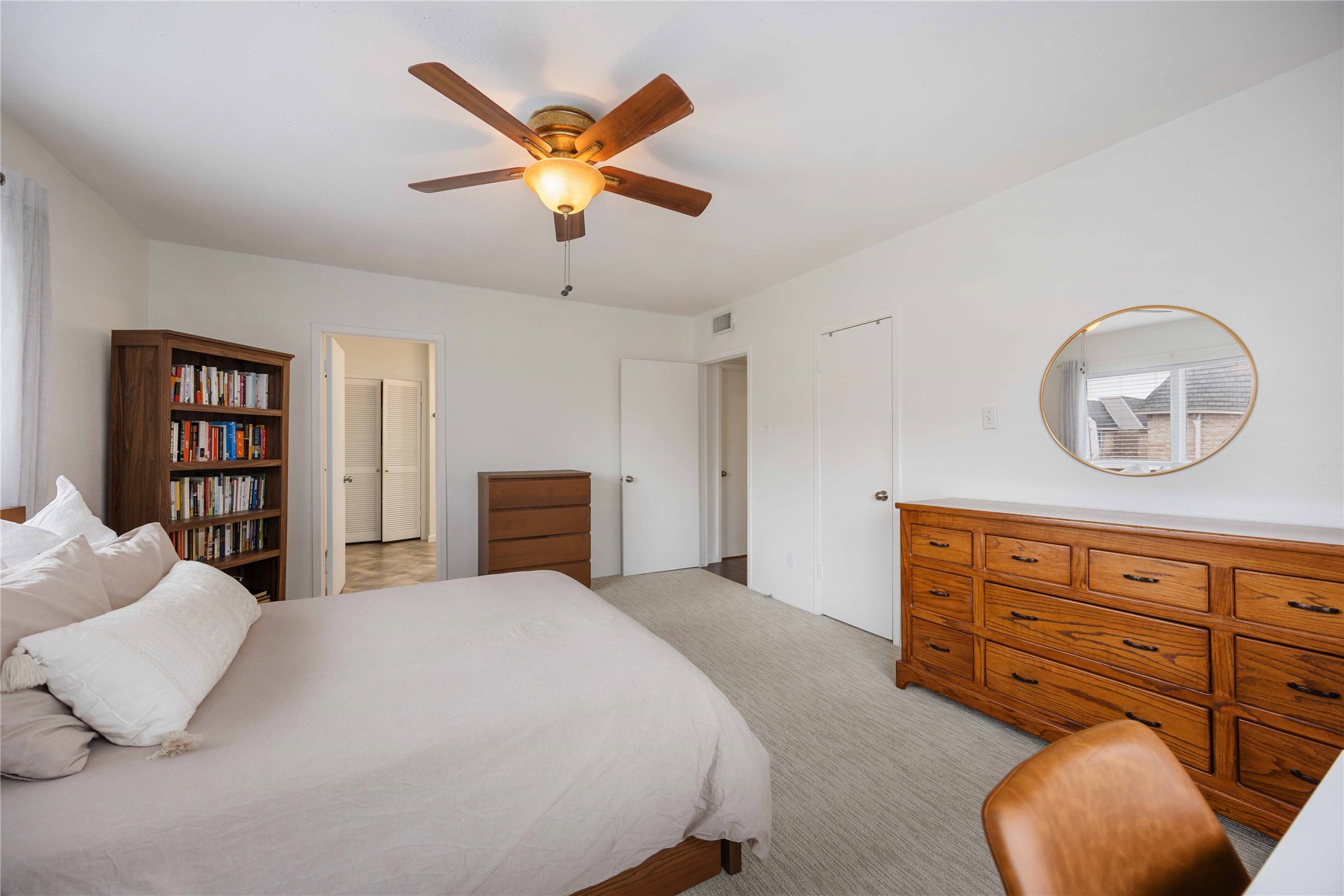 2230 South Piney Point Road, Unit 206 Houston, TX 77063 - Photo 13 of 24 Another view of the primary bedroom showing the entrance to the private ensuite bathroom. The door to the right leads into a walk-in closet.