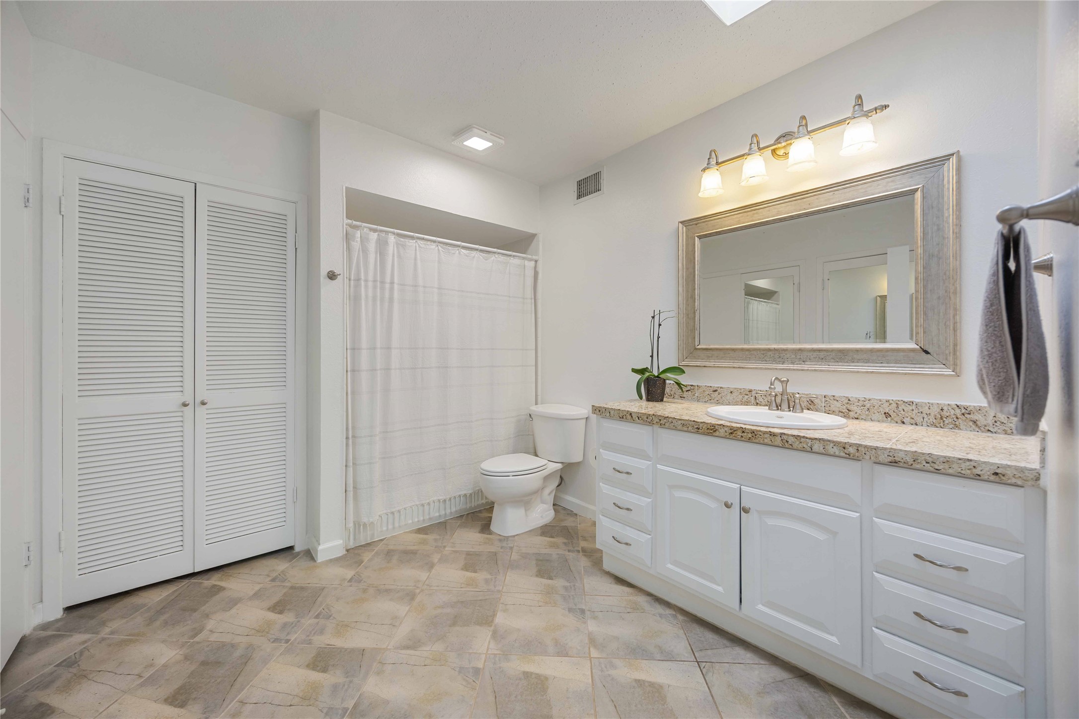 2230 South Piney Point Road, Unit 206 Houston, TX 77063 - Photo 15 of 24 The primary bathroom contains updated granite countertops and an abundance of closet storage.