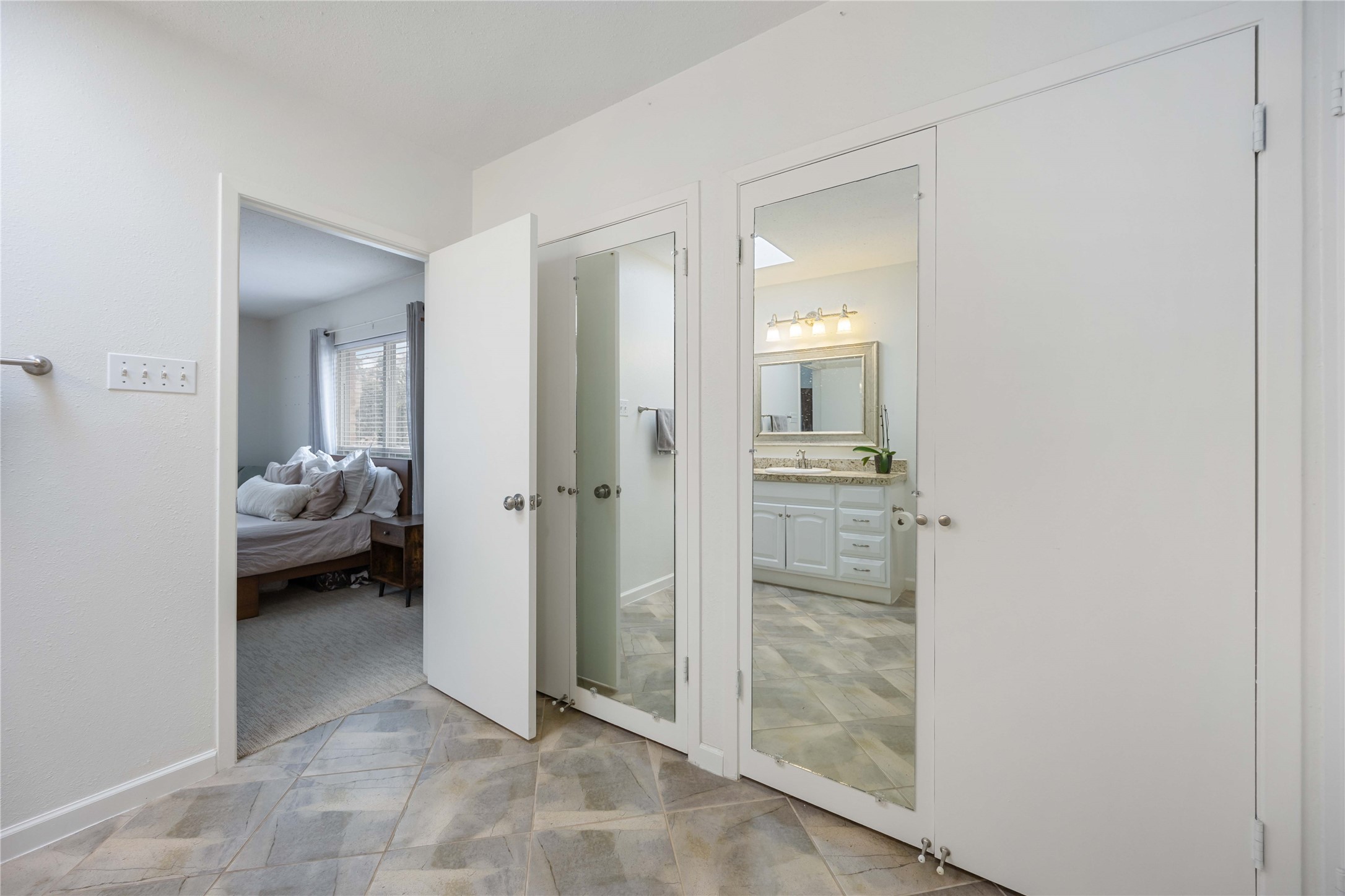 2230 South Piney Point Road, Unit 206 Houston, TX 77063 - Photo 17 of 24 Another view of the primary bathroom showing floor length mirrors and additional closet space.