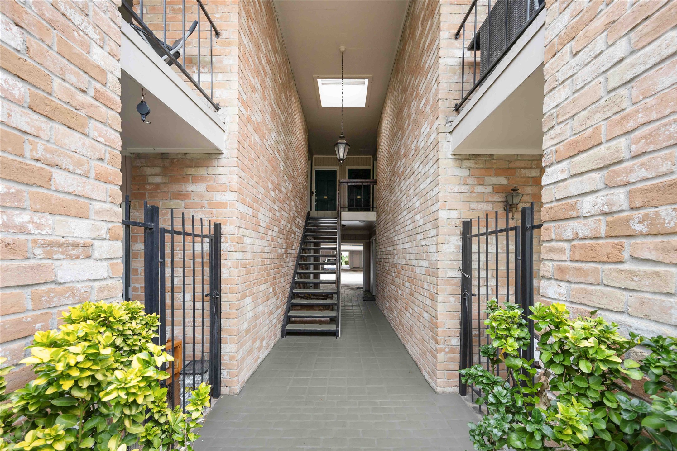 2230 South Piney Point Road, Unit 206 Houston, TX 77063 - Photo 2 of 24 The stairs leading up to the second-floor unit.