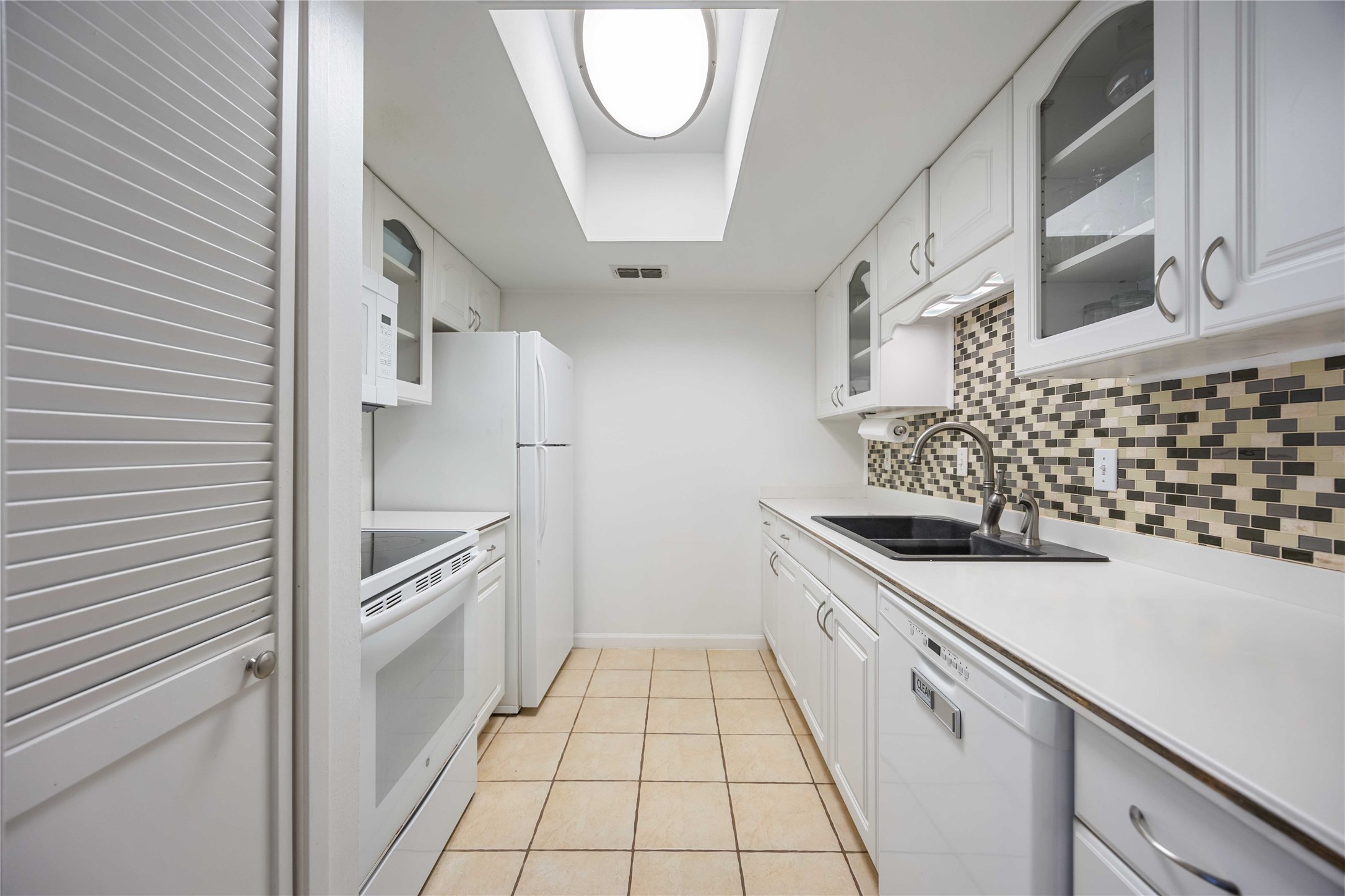 2230 South Piney Point Road, Unit 206 Houston, TX 77063 - Photo 7 of 24 Galley kitchen with pantry door to the left.