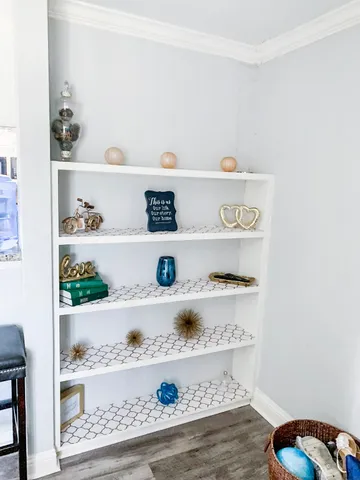 a shelf with books and knick knacks on it