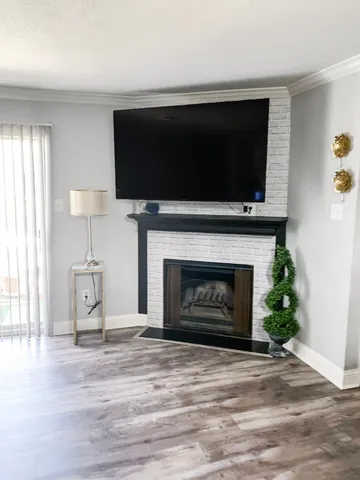 a living room with a fireplace and a flat screen tv