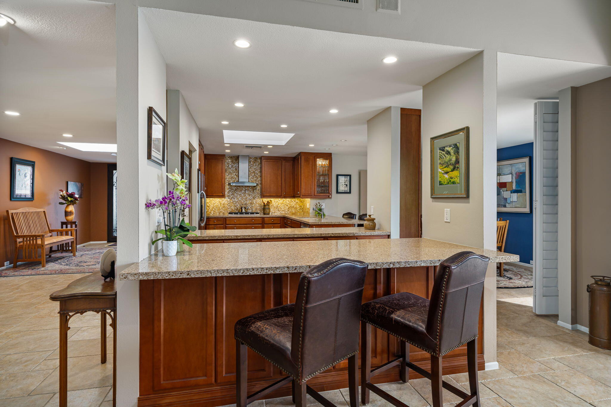 3 Tulane Court Rancho Mirage, CA 92270 - Photo 11 of 47 a dining hall with stainless steel appliances granite countertop a stove a sink a oven a dining table and chairs