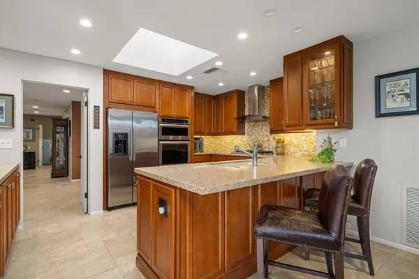 a kitchen with granite countertop a sink and cabinets