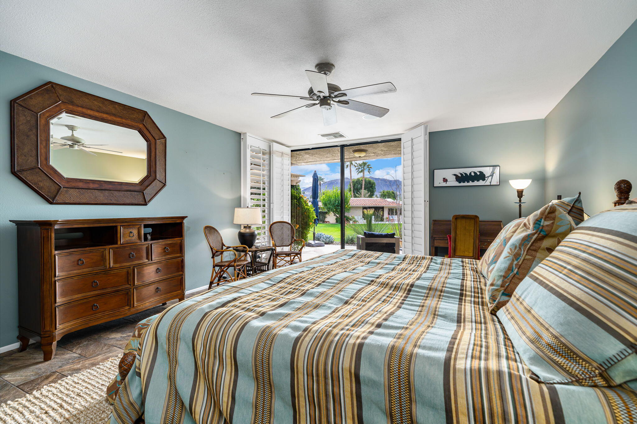 3 Tulane Court Rancho Mirage, CA 92270 - Photo 22 of 47 a bedroom with a bed a mirror on dresser and a large window
