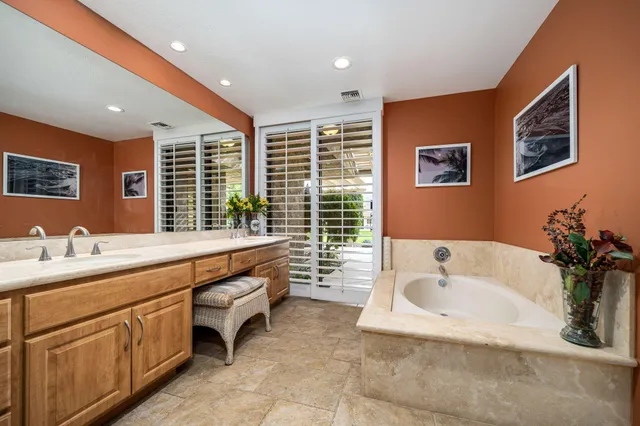 a bathroom with a granite countertop sink a shower and a mirror