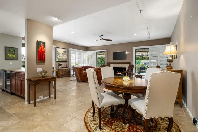 a living room with furniture large window and a fireplace