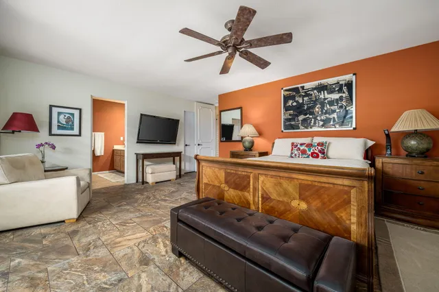 a patio with table and chairs and potted plants