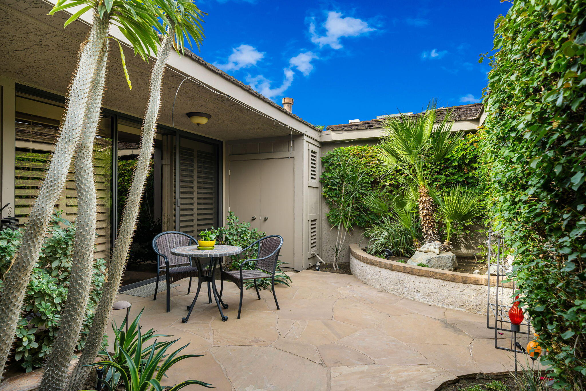 3 Tulane Court Rancho Mirage, CA 92270 - Photo 32 of 47 a patio with table and chairs and potted plants