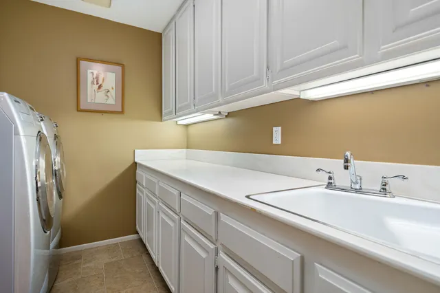 a view of a patio with couches table and chairs and potted plants