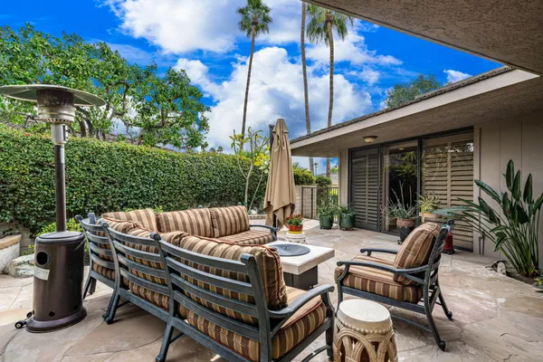 a view of a patio with a table chairs and a fire pit
