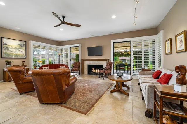 a living room with furniture ceiling fan and a fireplace