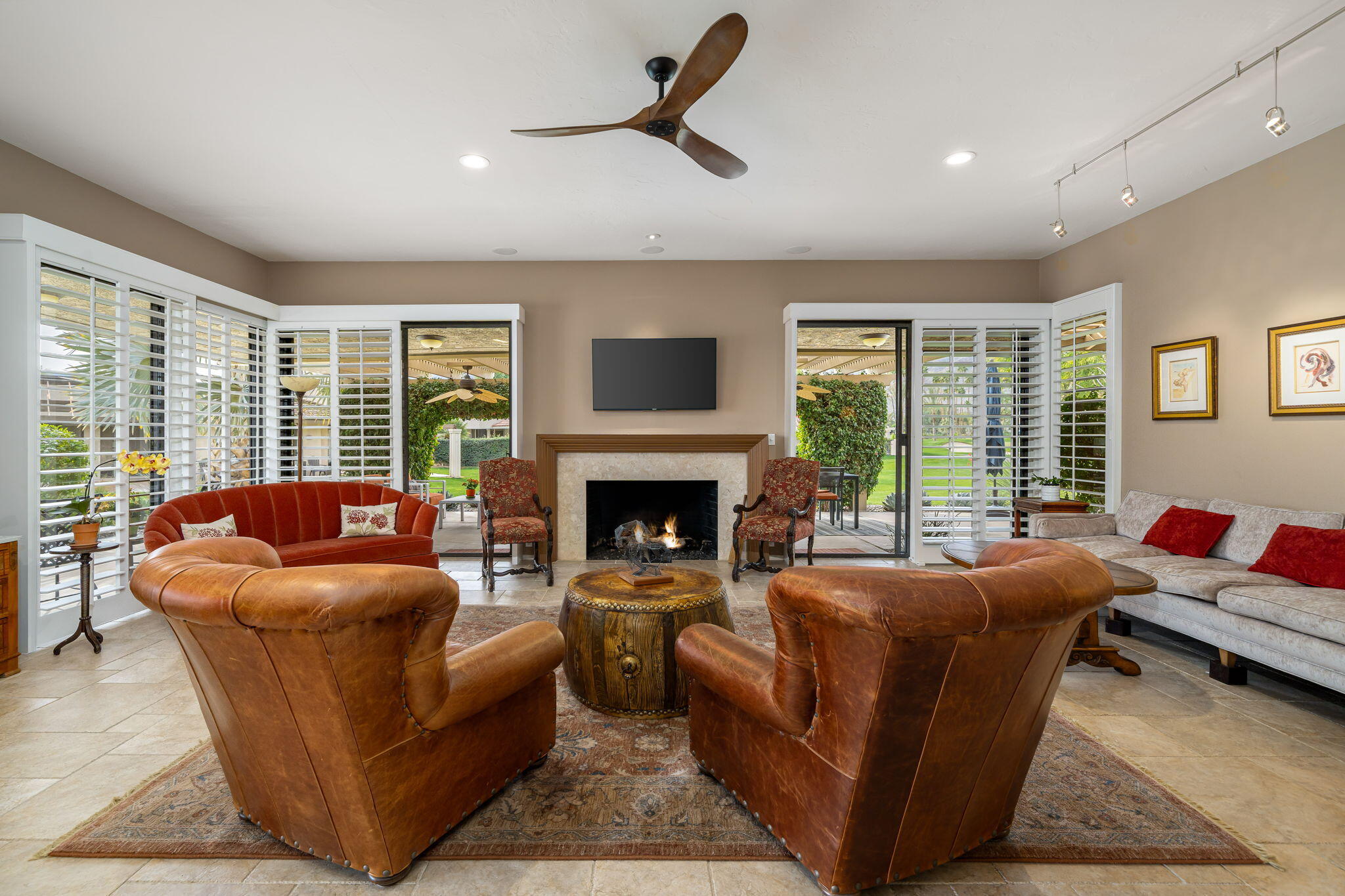 3 Tulane Court Rancho Mirage, CA 92270 - Photo 5 of 47 a living room with furniture ceiling fan and a fireplace