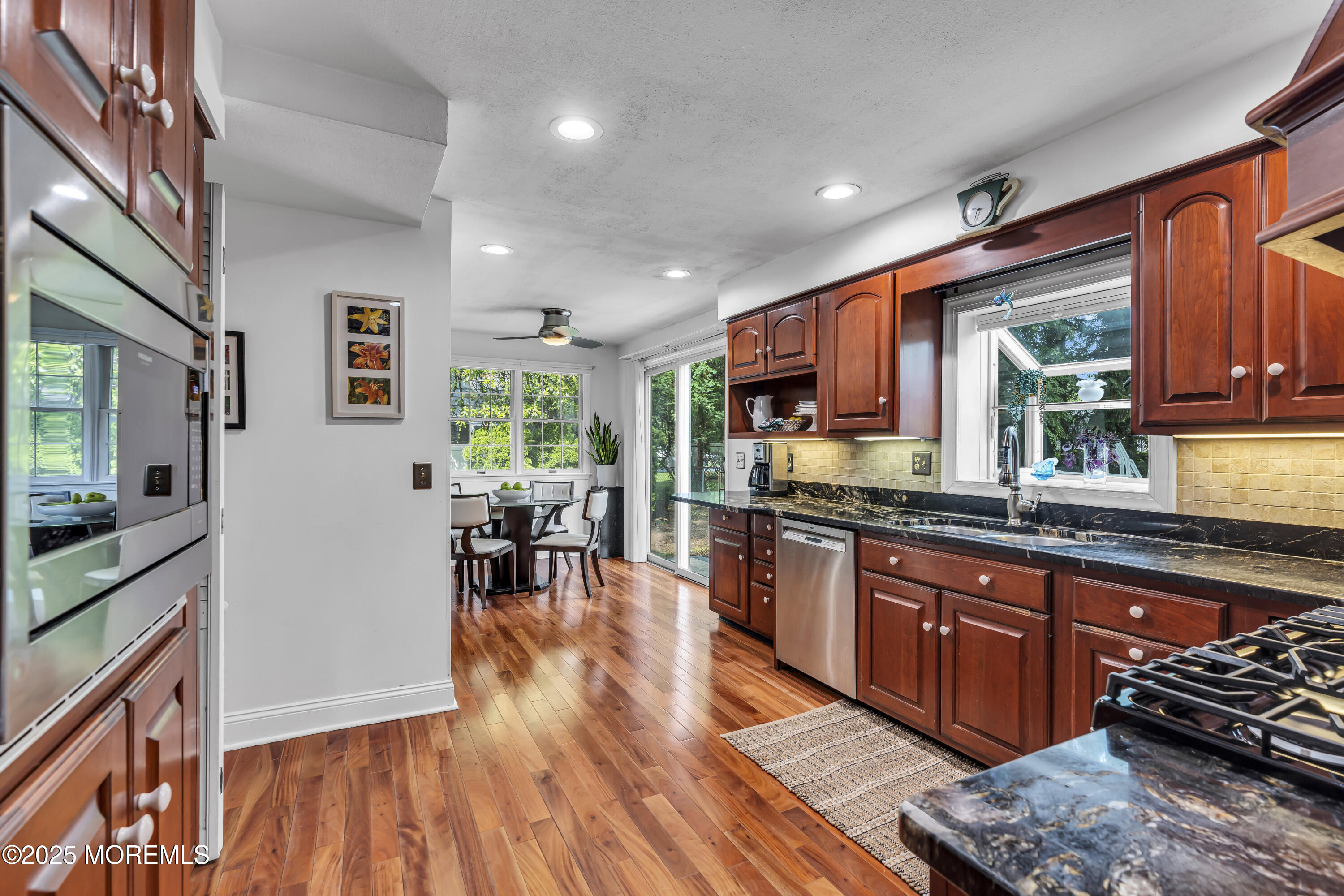 82 Ridge Road Fair Haven, NJ 07704 - Photo 13 of 39 a kitchen with stainless steel appliances granite countertop wooden floors and wooden cabinets