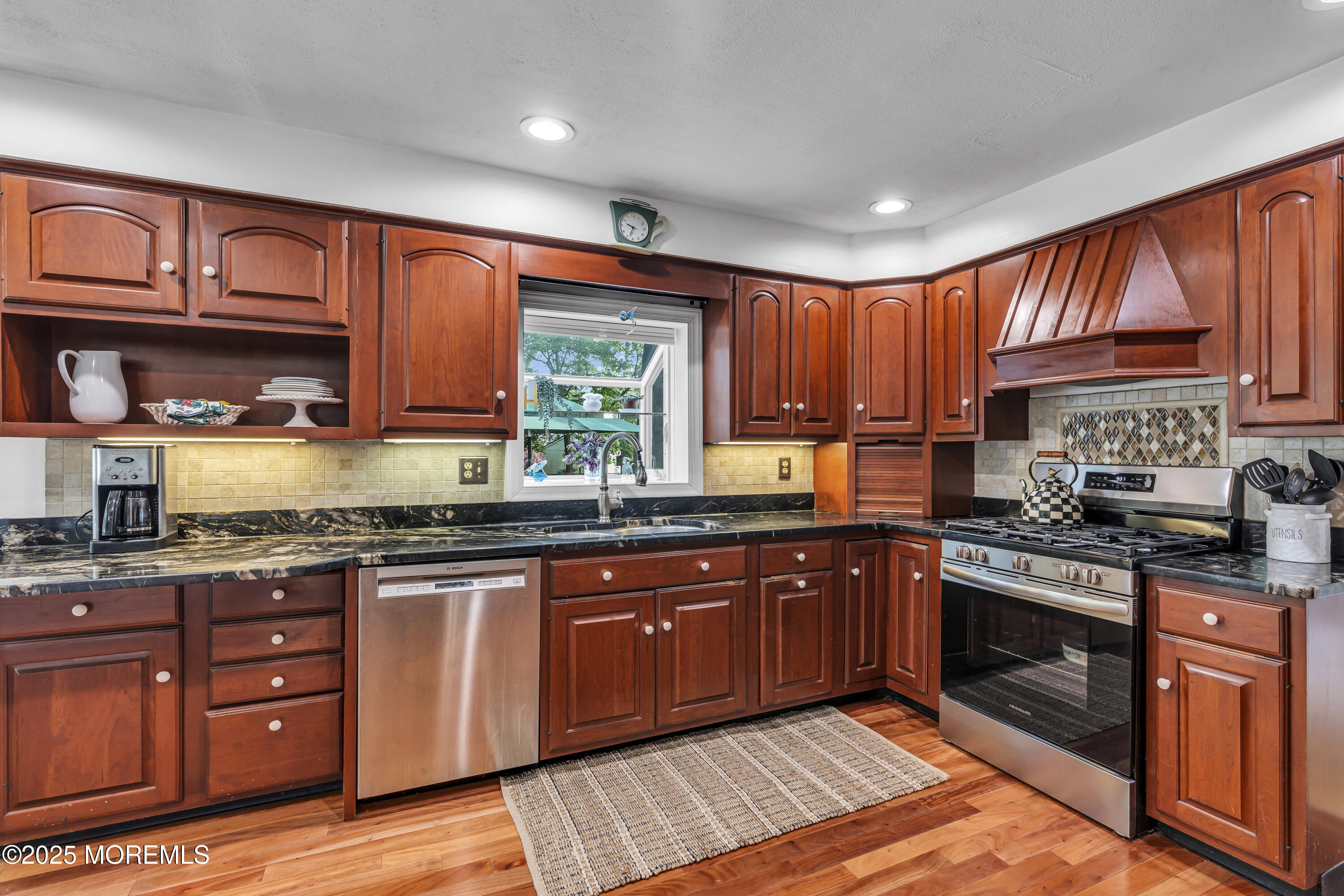 82 Ridge Road Fair Haven, NJ 07704 - Photo 14 of 39 a kitchen with stainless steel appliances granite countertop wooden cabinets a sink and a stove