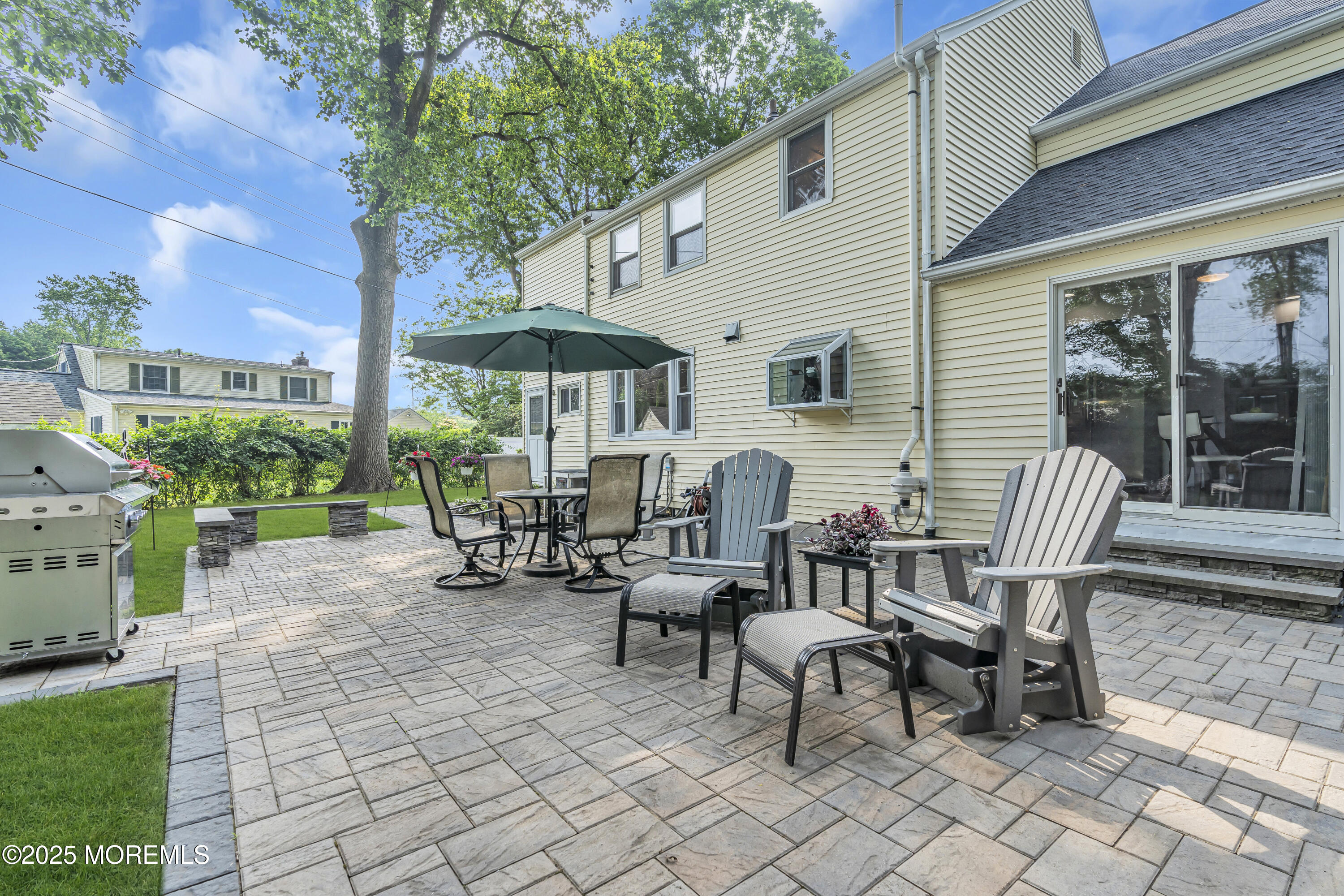 82 Ridge Road Fair Haven, NJ 07704 - Photo 36 of 39 a view of a patio with a dining table and chairs