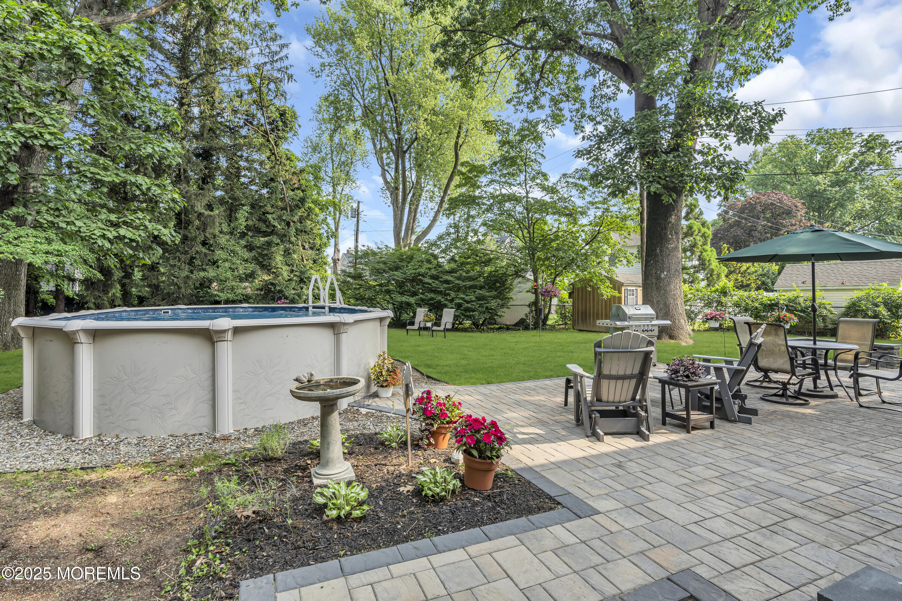 82 Ridge Road Fair Haven, NJ 07704 - Photo 38 of 39 a view of a patio with table and chairs potted plants and large tree