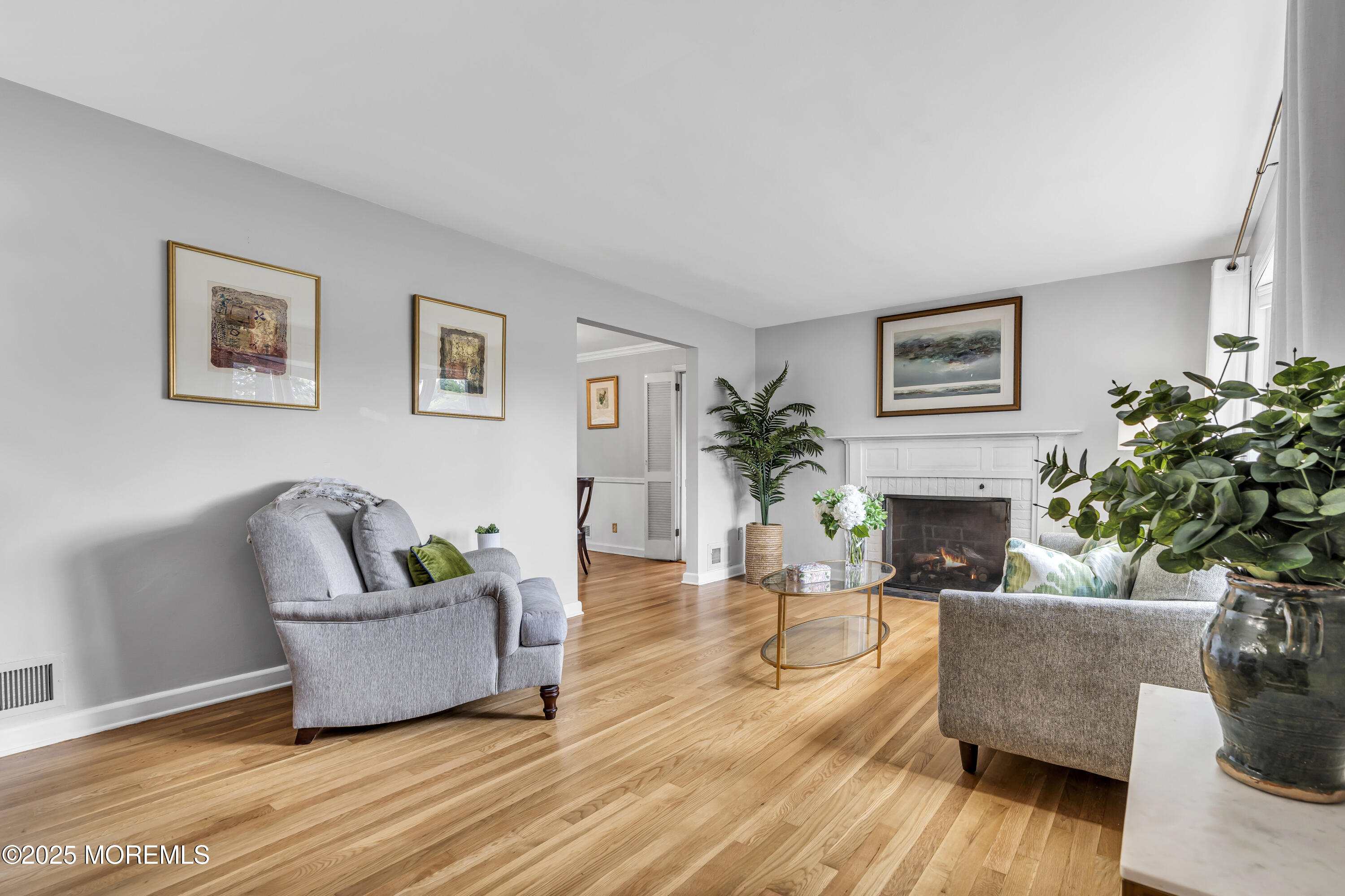 82 Ridge Road Fair Haven, NJ 07704 - Photo 4 of 39 a living room with furniture potted plant and a fireplace