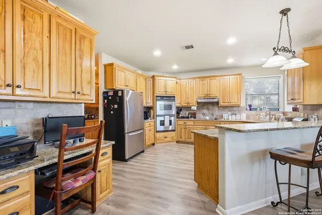 a large kitchen with kitchen island granite countertop lots of counter top space