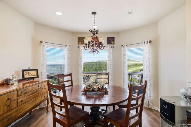 a living room with furniture kitchen view and a chandelier