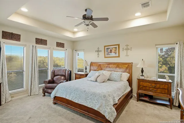 a bedroom with furniture and a large window