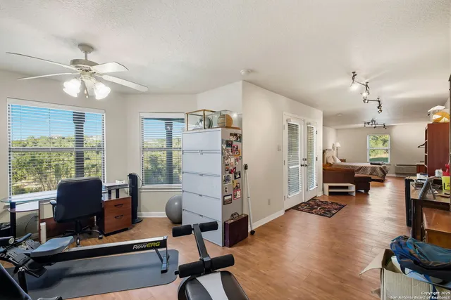 a bedroom with a bed a couch and chandelier