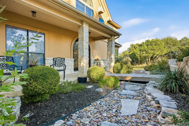 a view of a chairs and table in backyard
