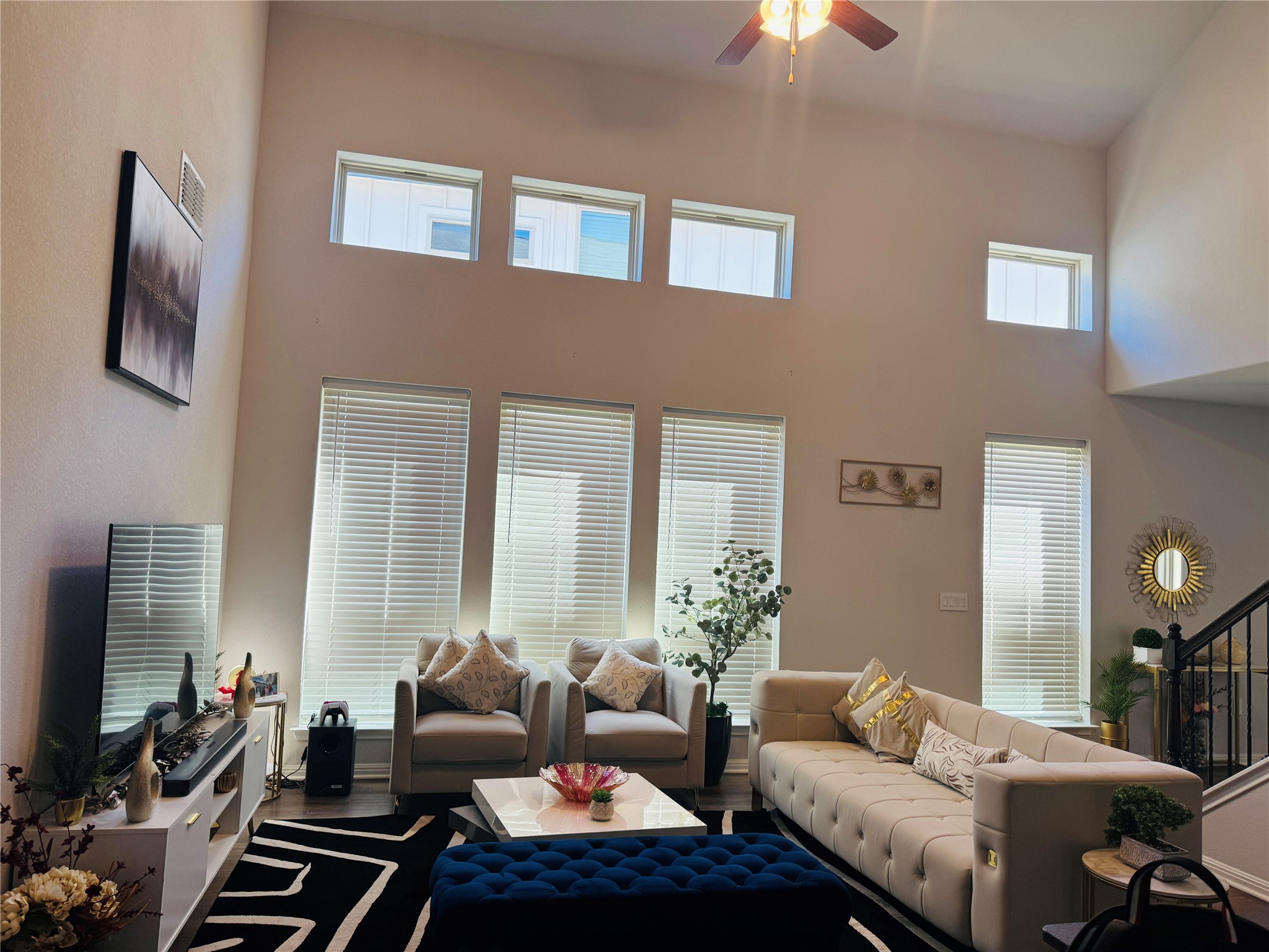 349 Rend Drive Leander, TX 78641 - Photo 6 of 21 Living room with a ceiling fan, healthy amount of natural light, a high ceiling, and wood finished floors