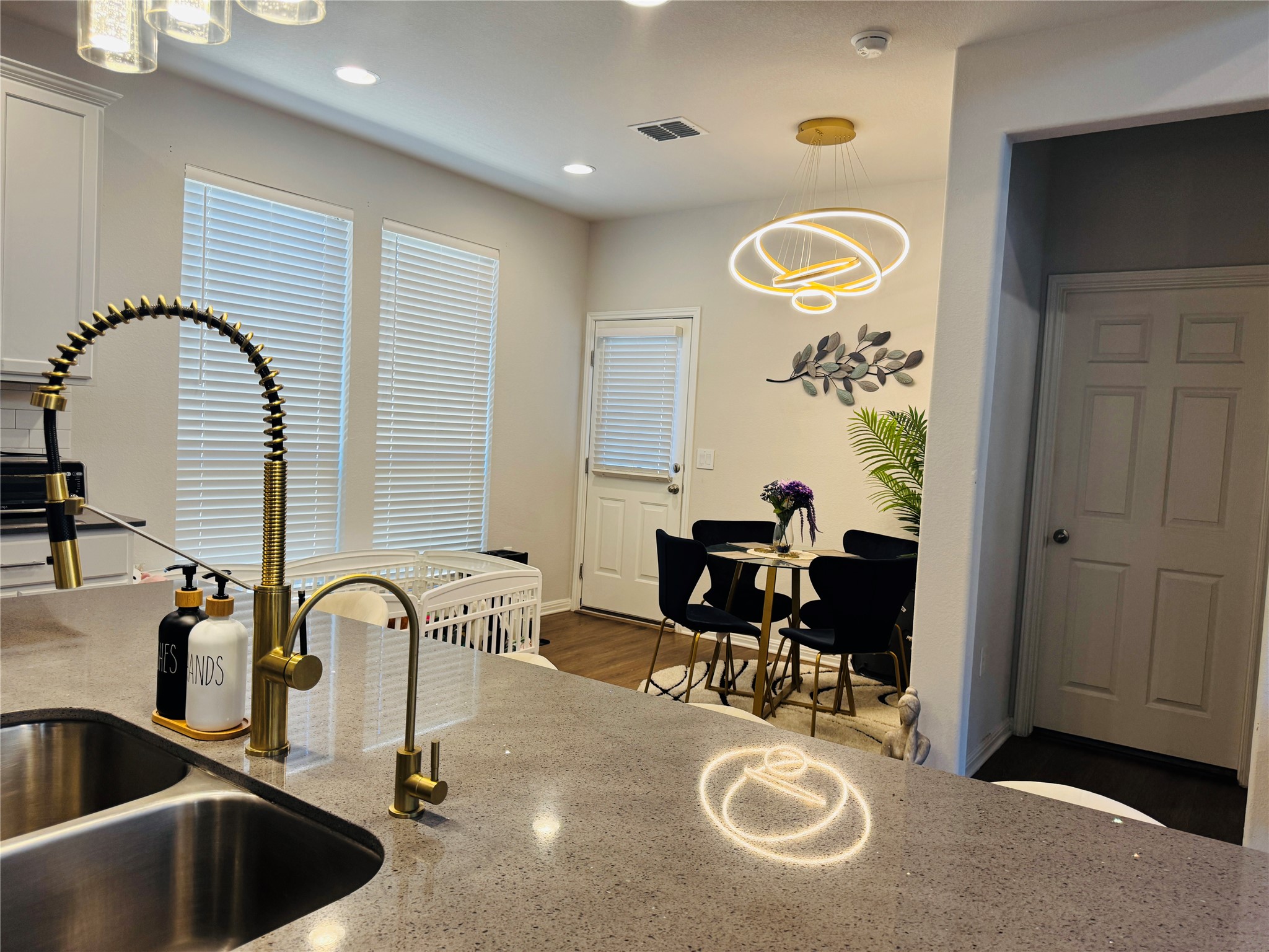 349 Rend Drive Leander, TX 78641 - Photo 9 of 21 Kitchen featuring light stone countertops, hanging lights, and light wood-style floors