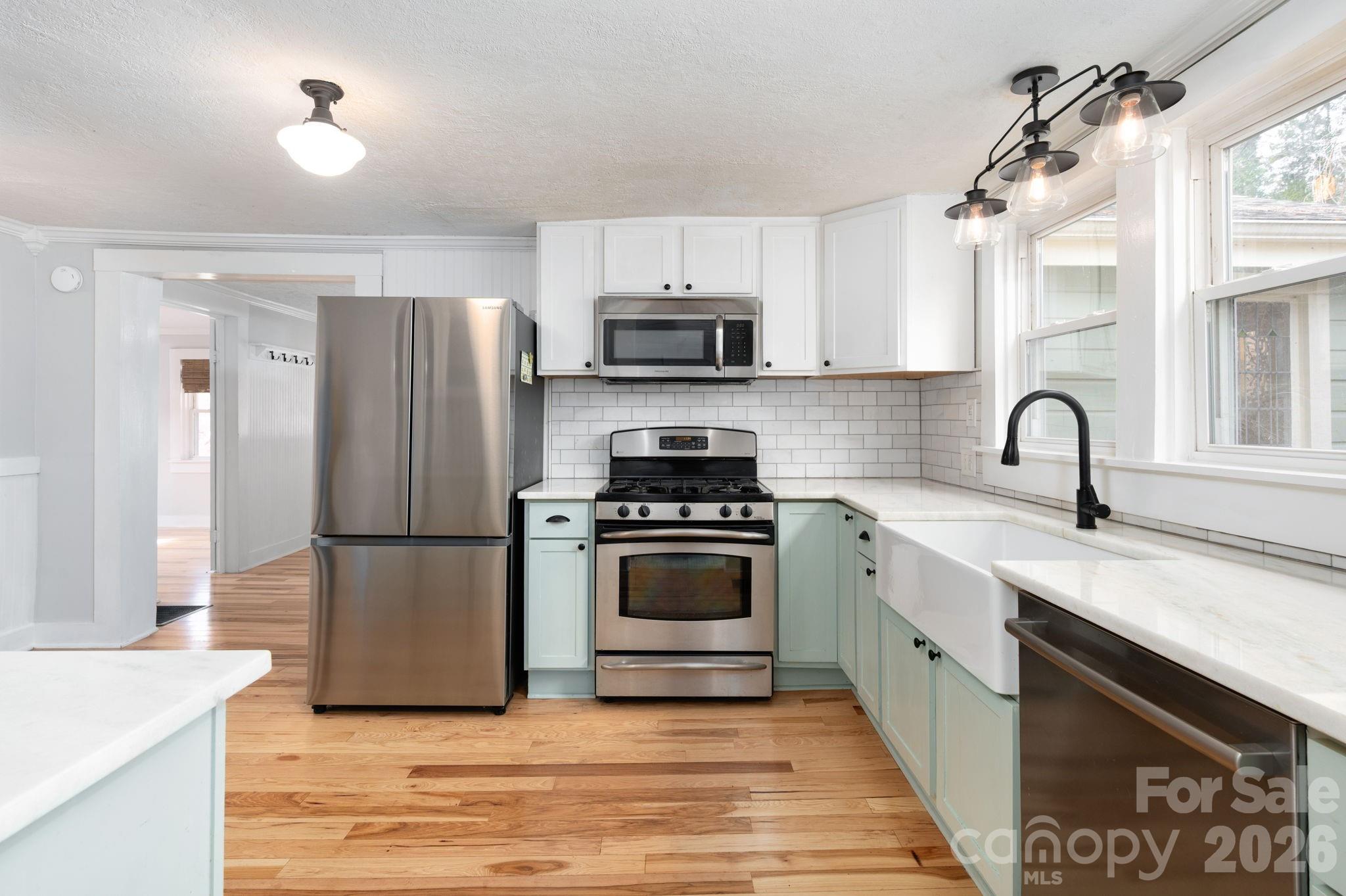 127 Shelburne Road Asheville, NC 28806 - Photo 12 of 28 a kitchen with a sink a stove and refrigerator