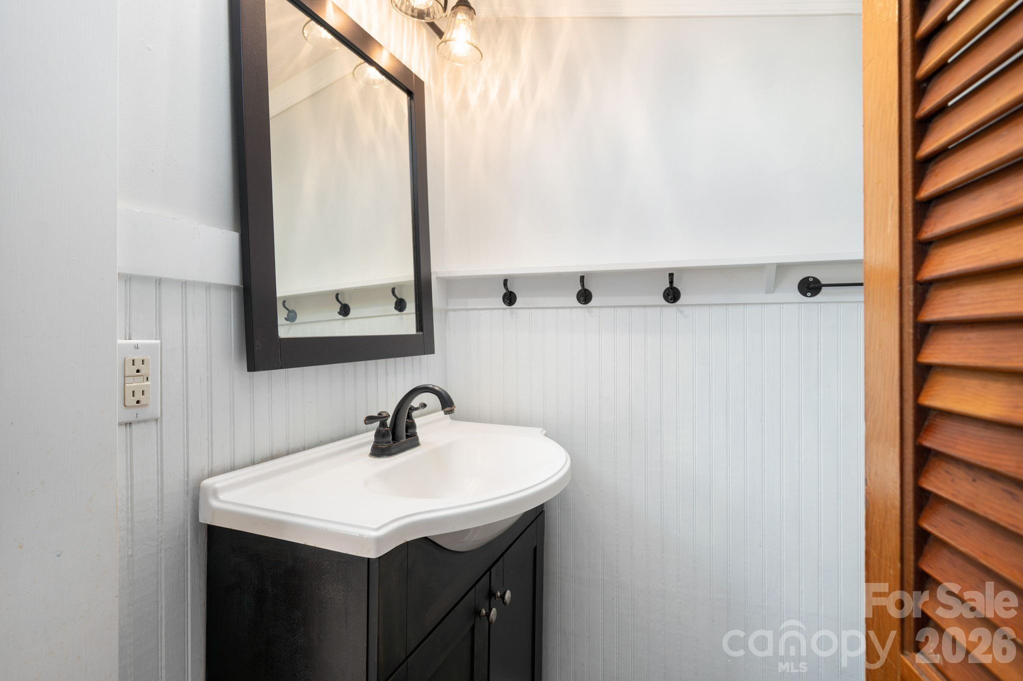 127 Shelburne Road Asheville, NC 28806 - Photo 19 of 28 a bathroom with a sink and a mirror