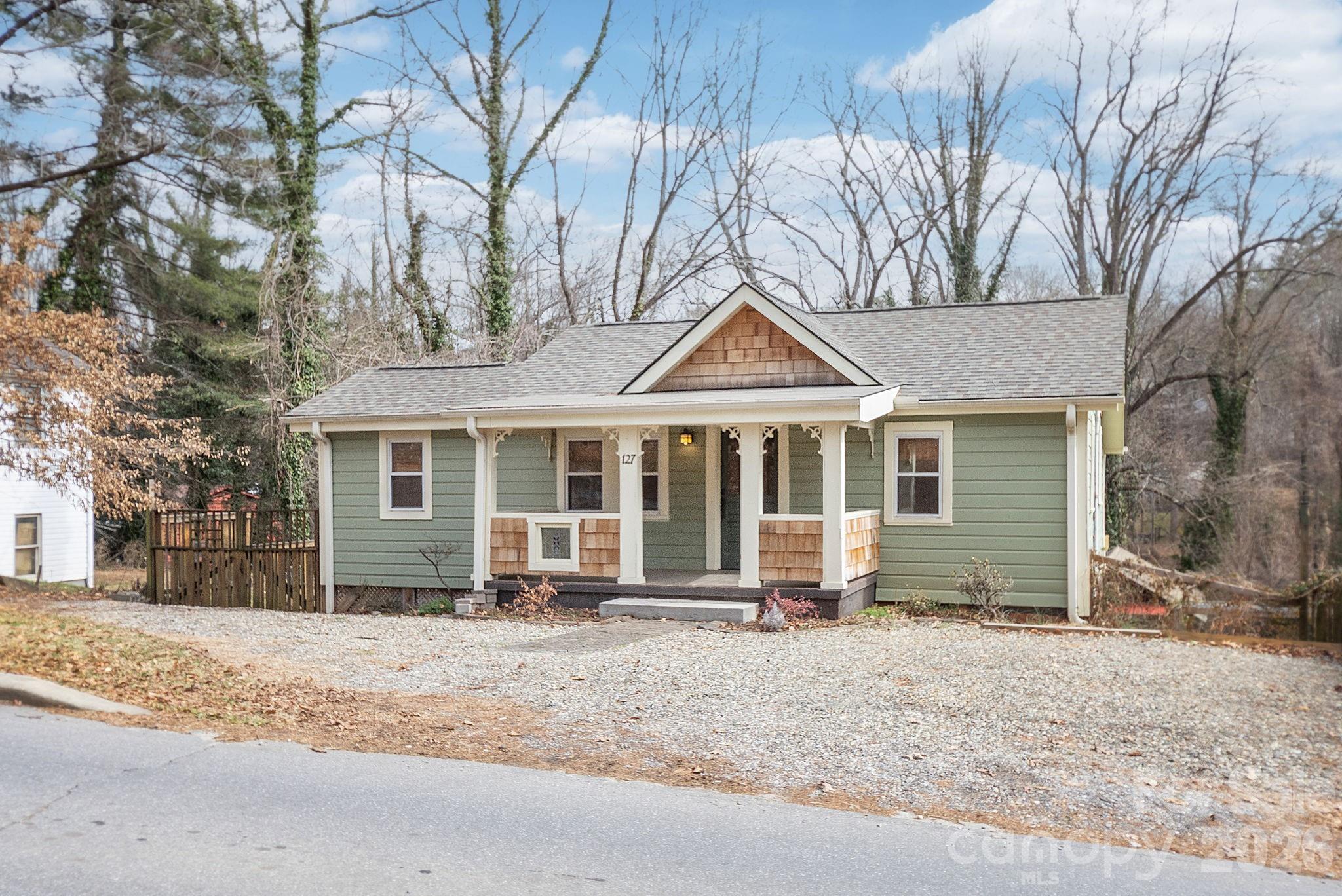 127 Shelburne Road Asheville, NC 28806 - Photo 2 of 28 a front view of a house with a yard covered in snow