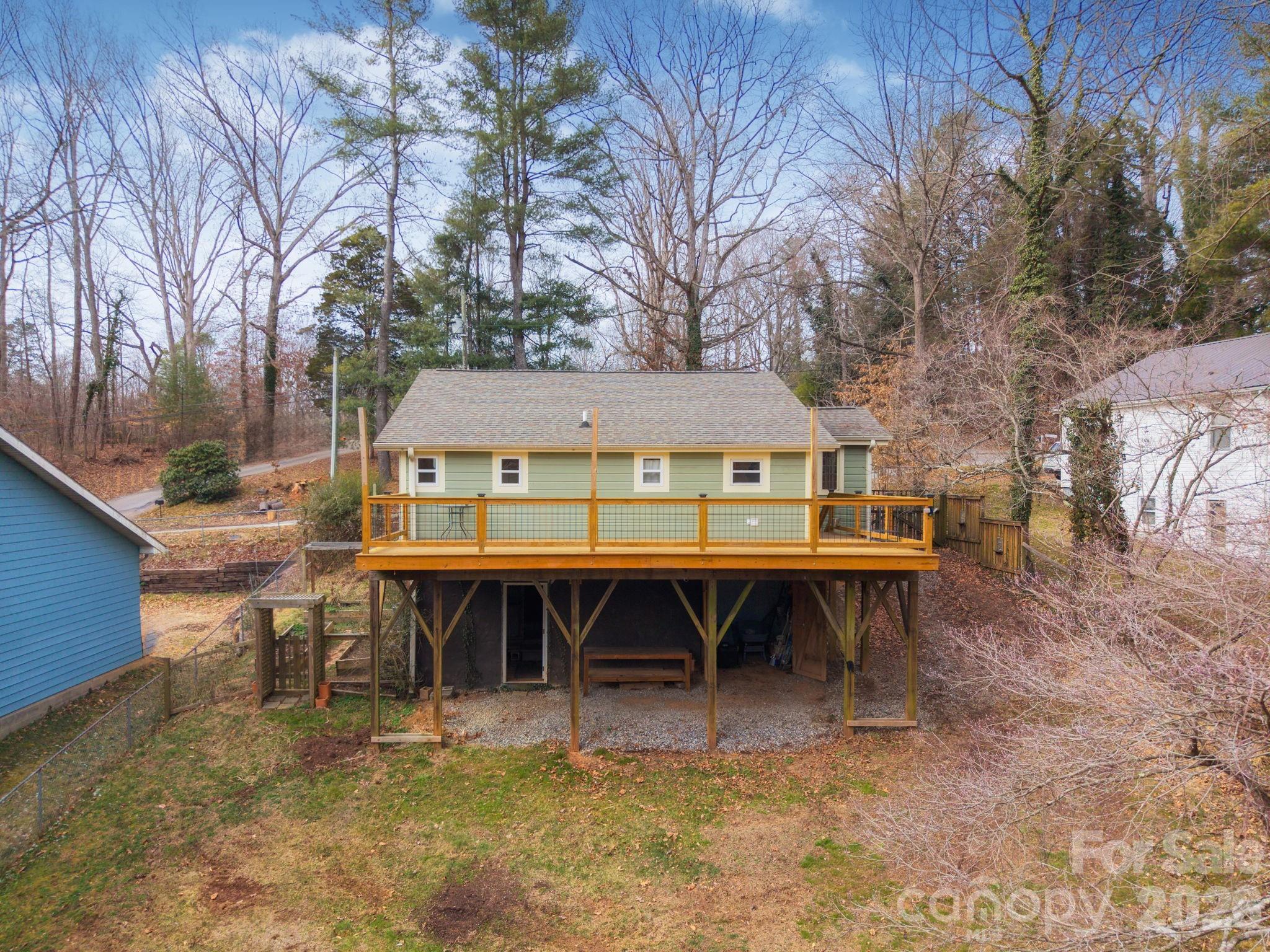 127 Shelburne Road Asheville, NC 28806 - Photo 22 of 28 a view of a chairs and table in a backyard of the house
