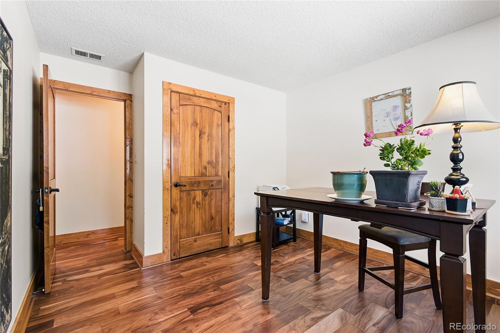 8790 South Warhawk Road Conifer, CO 80433 - Photo 17 of 41 a dining room with furniture and wooden floor
