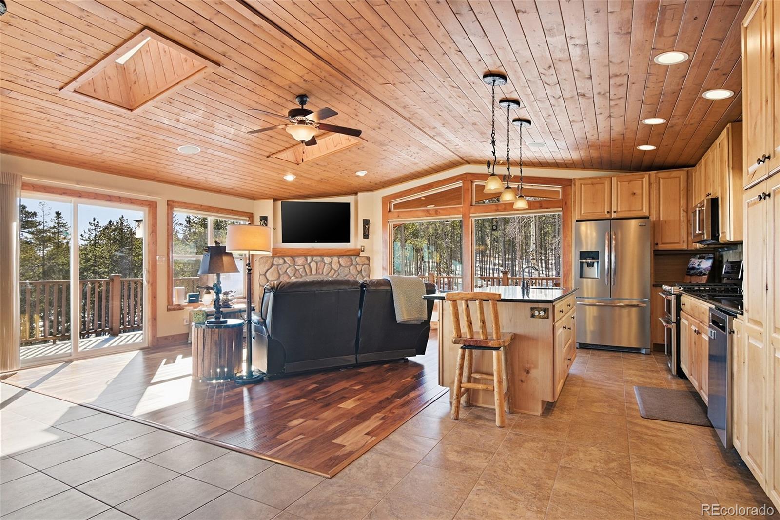 8790 South Warhawk Road Conifer, CO 80433 - Photo 3 of 41 a view of a dining room with furniture wooden floor and chandelier