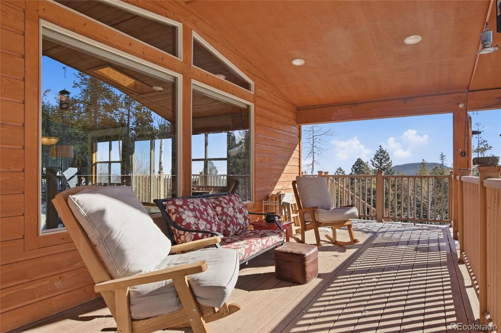 8790 South Warhawk Road Conifer, CO 80433 - Photo 32 of 41 a view of a balcony chairs and dining table