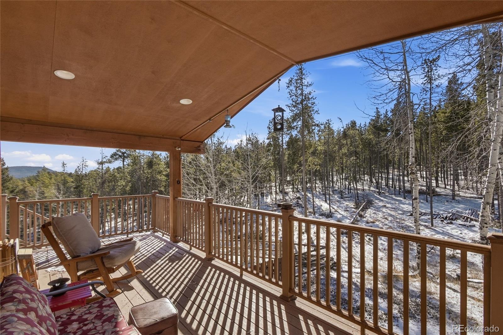 8790 South Warhawk Road Conifer, CO 80433 - Photo 33 of 41 a view of a balcony with wooden floor and outdoor seating