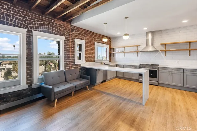 a kitchen with stainless steel appliances granite countertop a stove and a refrigerator