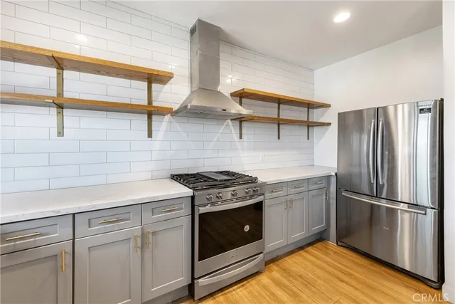 a large white kitchen with kitchen island a sink stainless steel appliances granite counter tops and a window