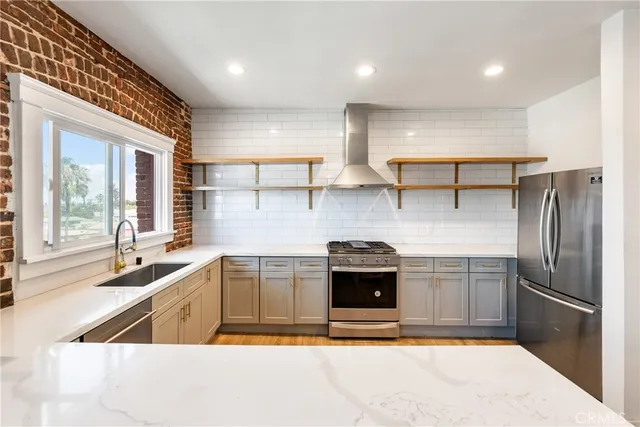 a view of a living room with kitchen view and wooden floor