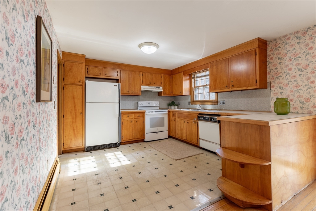51 Eldred Street Lexington, MA 02420 - Photo 12 of 30 a kitchen with a sink a refrigerator and cabinets