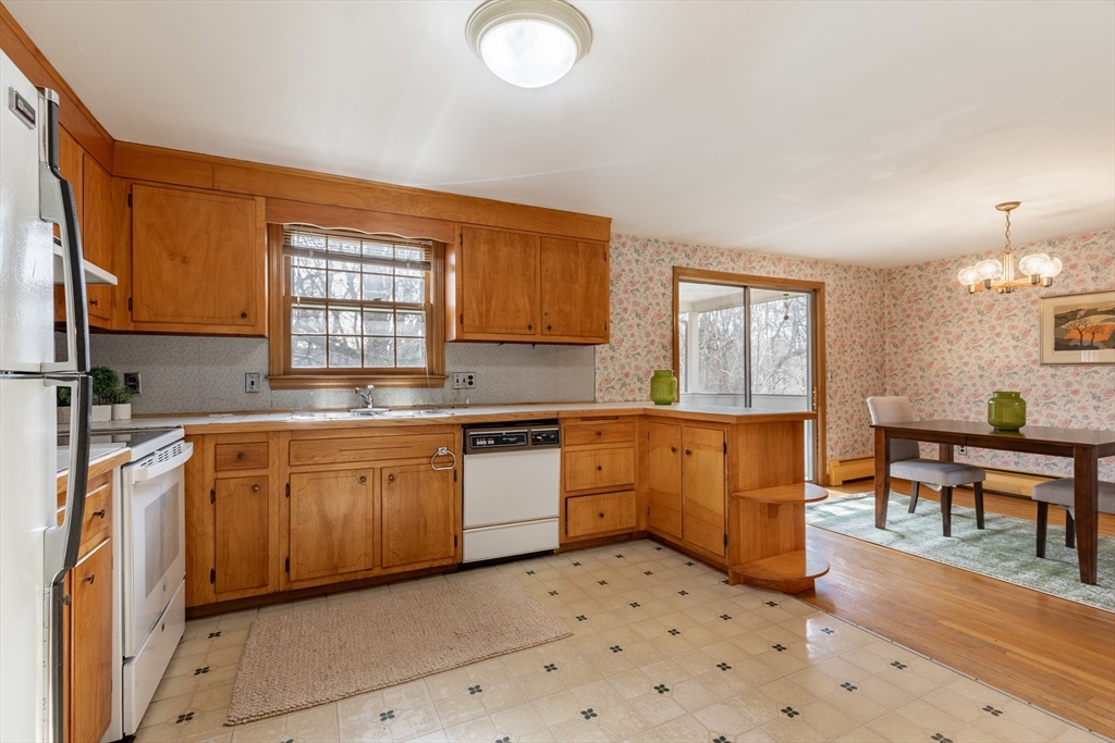 51 Eldred Street Lexington, MA 02420 - Photo 13 of 30 a kitchen with stainless steel appliances granite countertop a sink and cabinets