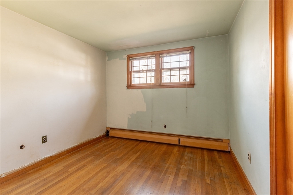 51 Eldred Street Lexington, MA 02420 - Photo 17 of 30 an empty room with wooden floor and windows