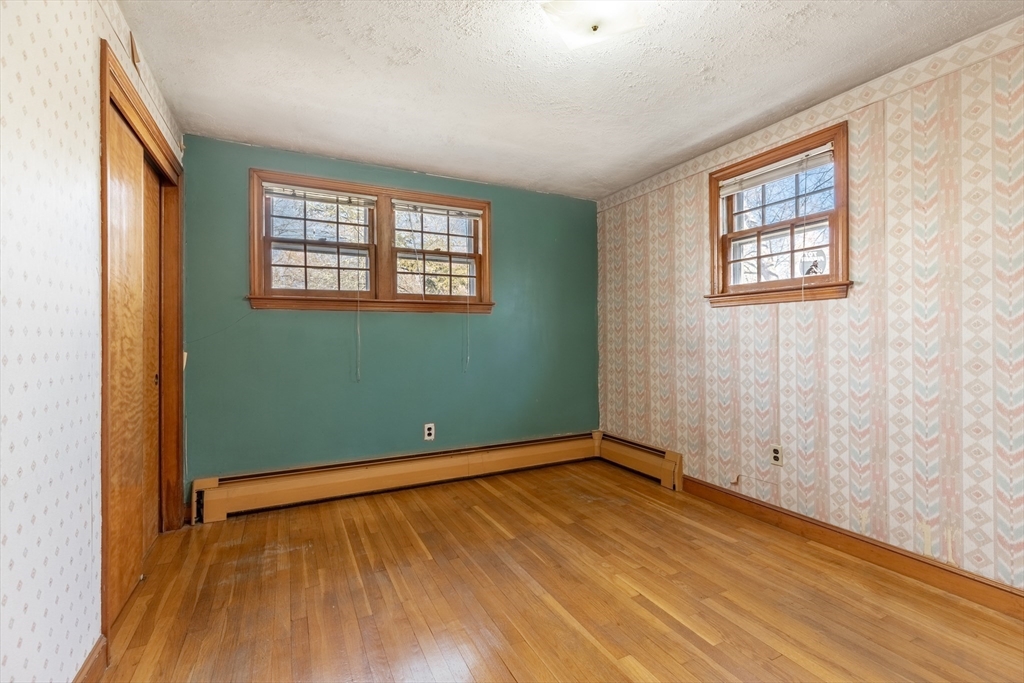 51 Eldred Street Lexington, MA 02420 - Photo 18 of 30 an empty room with wooden floor and windows
